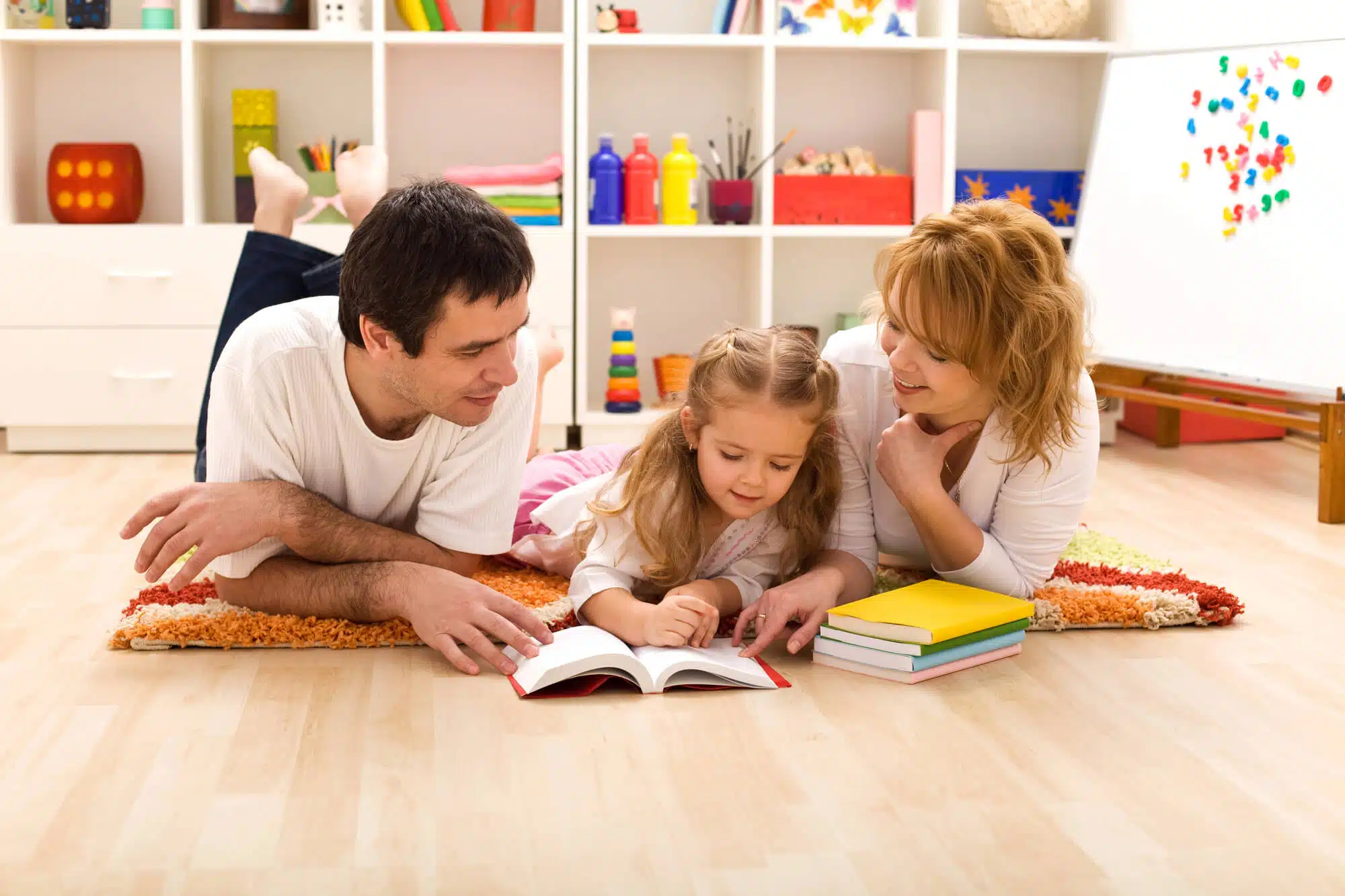 Strategies to Reinforce Learning at Home 2 girl reading with parents after going to a k-12 learning center