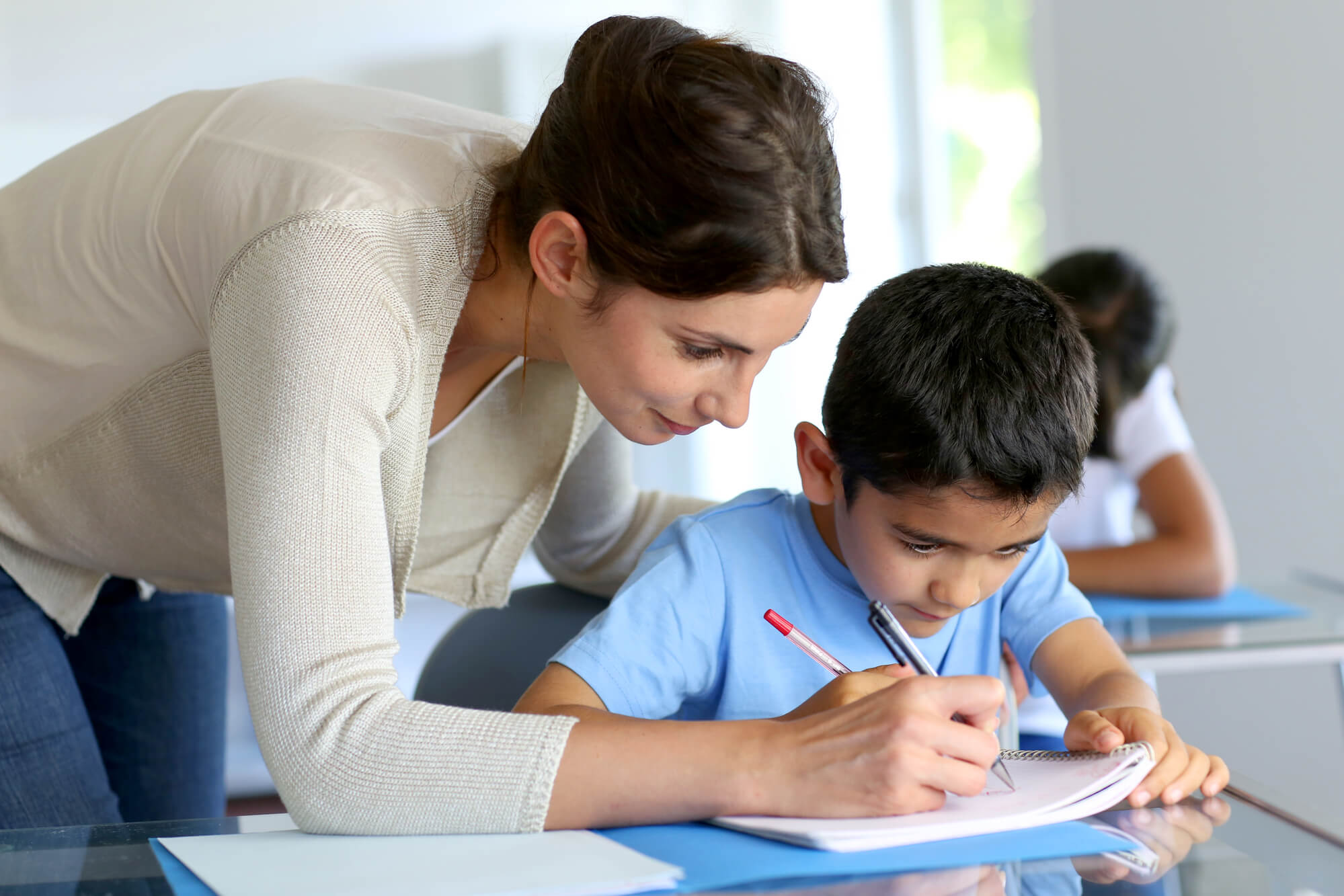 tutor from a learning franchise helping a boy