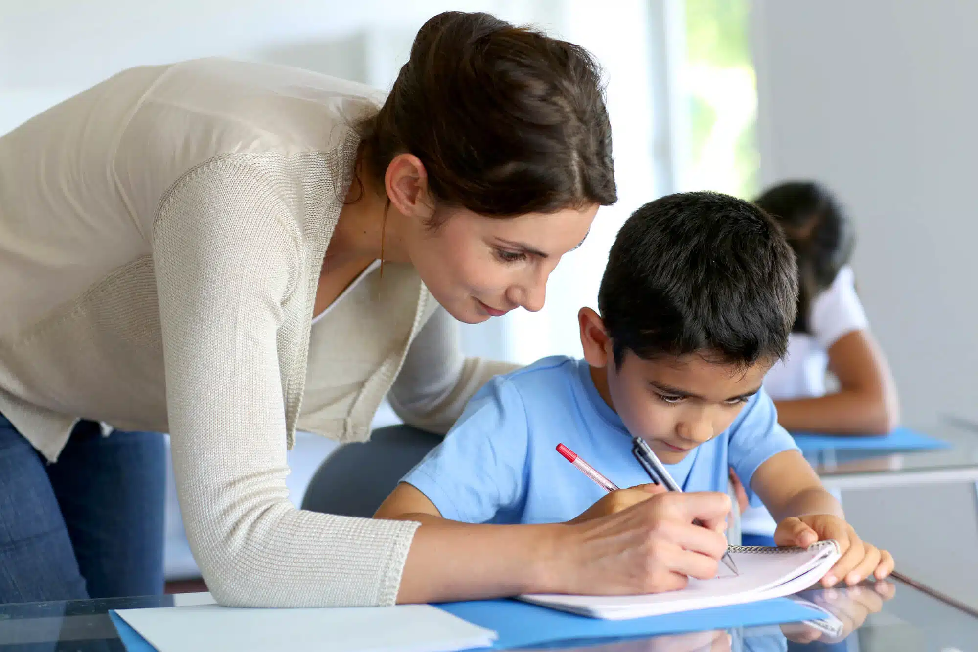 tutor from a learning franchise helping a boy