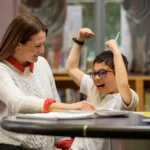 Are There Tutoring Benefits For Parents? 1 Child celebrating success with tutor at the Kindergarten and Beyond Franchise.